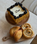Armenian honey cake bordered with blackberries and blueberries, Dad written across the top, with meat piroshki and feta borek — Father's Day gift box from Tatik's Delights, Southbank Melbourne